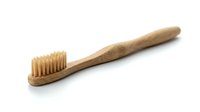Natural bamboo toothbrush with soft bristles isolated on white background. Eco-friendly dental hygiene product for sustainable oral care and zero waste lifestyle.