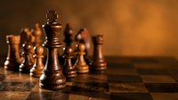 Wooden chess pieces on board with warm lighting showcasing strategy and competition in classic board game for business concepts and intellectual challenges.