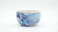 Handmade ceramic bowl with blue watercolor landscape design, isolated on white background. Perfect for home decor, tableware, and product design projects.