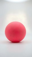 Vibrant pink rubber ball isolated on white background, suitable for sports, recreation, toy, and product design applications.