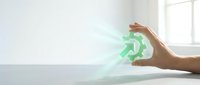 Hand holding glowing green recycling symbol with light rays, representing sustainability, environmental responsibility, and eco-friendly business practices.