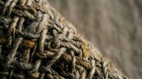 Natural jute rope texture with detailed woven fibers and rustic brown tones for craft and nautical design projects.