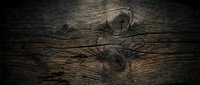 Dark weathered wood plank surface with natural grain patterns and knots creating rustic texture for backgrounds and design projects.