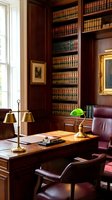 Elegant traditional home office with dark wood built-in bookshelves, leather chair, brass banker's lamp and classic law books for professional workspace design.