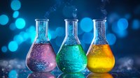 Three laboratory flasks with colorful bubbling chemical solutions in pink, green and yellow against blue bokeh background for science research.