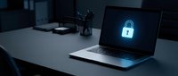 Cybersecurity concept with glowing padlock icon on laptop screen in modern office workspace for data protection and digital security solutions.