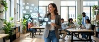 Woman entrepreneur in casual business attire presenting digital marketing strategy with holographic icons in modern office workspace with diverse team collaborating at desks.