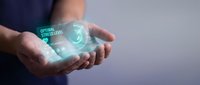 Caucasian male hand holding transparent holographic display showing software architecture interface with glowing green circular design elements for technology and digital innovation concepts.