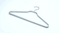 Silver metal clothes hanger isolated on white background, minimalist wardrobe accessory for clothing storage and organization.