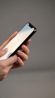 Female hands holding modern smartphone with blank screen against neutral background for mobile app mockup and digital communication concepts.