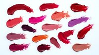 Colorful lipstick smears and swatches in various shades from pink to red purple isolated on white background for cosmetic beauty makeup design.