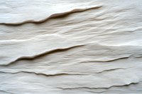 Abstract white layered texture with soft wavy lines and gentle shadows creating organic ripple effect. Natural stone or paper-like surface for modern minimal design backgrounds.