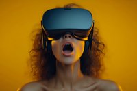 Young African American woman with curly hair wearing VR headset expressing amazement against vibrant yellow background, capturing modern technology experience.