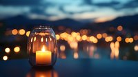 Glowing candle in glass lantern against blurred city lights at dusk creates romantic ambiance, soft bokeh effect adds warmth to evening atmosphere.