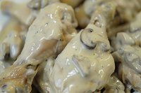 Creamy mushroom sauce with sliced champignons in white cream sauce, macro food photography showing texture and ingredients for restaurant menu.