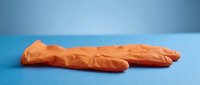 Isolated orange latex glove on blue background, ready for medical, healthcare, safety, and design applications including presentations and marketing materials.