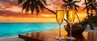 Two champagne glasses on wooden table at tropical beach sunset with palm trees and turquoise ocean for romantic vacation celebration and luxury resort dining.