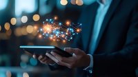 Businessman holding digital tablet with glowing network hologram, representing digital transformation and connectivity in corporate environment.