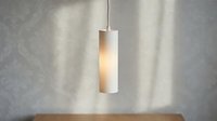 Minimalist pendant lamp with cylindrical frosted glass shade and metal fixture hanging above wooden surface, suitable for modern interior design and home decor projects.