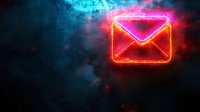 Glowing neon pink email envelope icon against dark smoky background with blue and red lighting effects, modern communication concept for digital marketing.