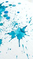 Blue watercolor paint splashes and drops scattered on white paper creating abstract artistic texture for creative projects and design backgrounds.