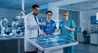 Medical professionals collaborating with digital technology interface in modern hospital laboratory for healthcare innovation and research analysis.