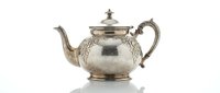 Elegant silver teapot with ornate handle and decorative lid isolated on white background for luxury dining and hospitality design projects.