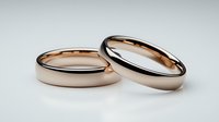 Elegant rose gold wedding bands on white background, classic rounded design showing commitment and eternal love. Suitable for wedding and engagement photography.
