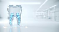 Transparent tooth model with blue internal structure displayed on reflective surface in modern dental clinic environment for educational and marketing purposes.