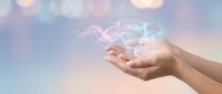 Cupped hands releasing glowing energy waves with colorful bokeh lights background for wellness meditation and spiritual healing concepts.