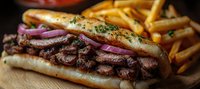Grilled steak sandwich with tender sliced beef, red onions and herbs on crusty baguette, served with golden french fries on wooden cutting board. Close up panoramic view.