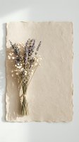 Dried lavender and baby's breath bouquet on handmade paper background for natural wedding decor and craft projects.