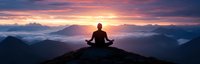Silhouette of person meditating on mountain summit at sunrise, panoramic view with dramatic purple and orange sky above misty valleys and peaks.