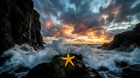 Orange starfish on rocky shore with dramatic sunset sky and crashing waves creating powerful seascape scene for nature and marine life concepts.