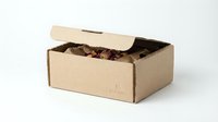 Cardboard shipping box filled with assorted chocolate candies and truffles on white background, perfect for e-commerce packaging and delivery services.