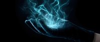 Glowing blue energy swirls above open palm creating magical light effect on dark background for fantasy and supernatural concepts.