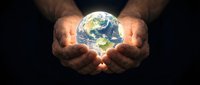 Hands holding glowing Earth planet against dark background, symbolizing environmental protection, sustainability, and global responsibility for conservation efforts.