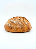 Freshly baked artisan sourdough loaf with crispy golden crust and flour dusting, isolated on white background for bakery, food, and culinary design use.