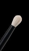 Makeup brush with soft white bristles and black handle isolated on transparent background, ready for beauty, cosmetics, and design projects.