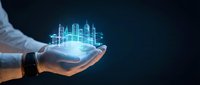 Male hand in business suit holding glowing holographic cityscape with digital buildings and network connections, representing smart city technology, urban development, and future innovation.
