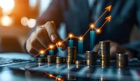 Growing stacks of coins with upward trending graph arrows showing financial growth and investment success on dark background with bokeh light effect.