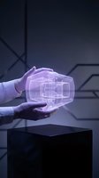 Scientist in protective gloves holding glowing purple holographic cube with digital wireframe design against dark tech background for innovation and technology concepts.