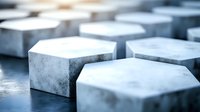 Hexagonal concrete blocks arranged in geometric pattern with selective focus and soft lighting creating modern architectural background texture.