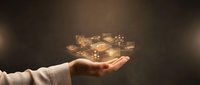 Business professional hand presenting golden digital logistics icons including delivery truck, airplane, ship and warehouse symbols floating above palm.