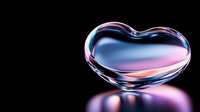 Transparent heart-shaped glass object with pink and blue gradient reflections on black background, floating with soft shadow beneath. Artistic macro photography.