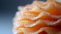 Delicate layers of fresh salmon sashimi arranged in waves create elegant texture and pattern, macro photography highlights translucent fish texture and natural oils.