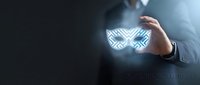 Businessman in suit holding glowing digital butterfly icon, representing innovation and enterprise solutions for corporate technology and business transformation concepts.