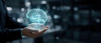 Businessman holding glowing digital brain hologram in palm representing artificial intelligence, machine learning and innovative technology solutions.