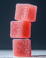 Pink sugar-coated gummy candies stacked on dark background, isolated confectionery for food packaging, advertising, and dessert design projects.