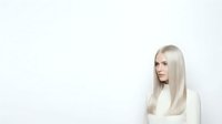 Caucasian woman with long platinum blonde hair wearing white sweater, isolated on white background for design and commercial use.